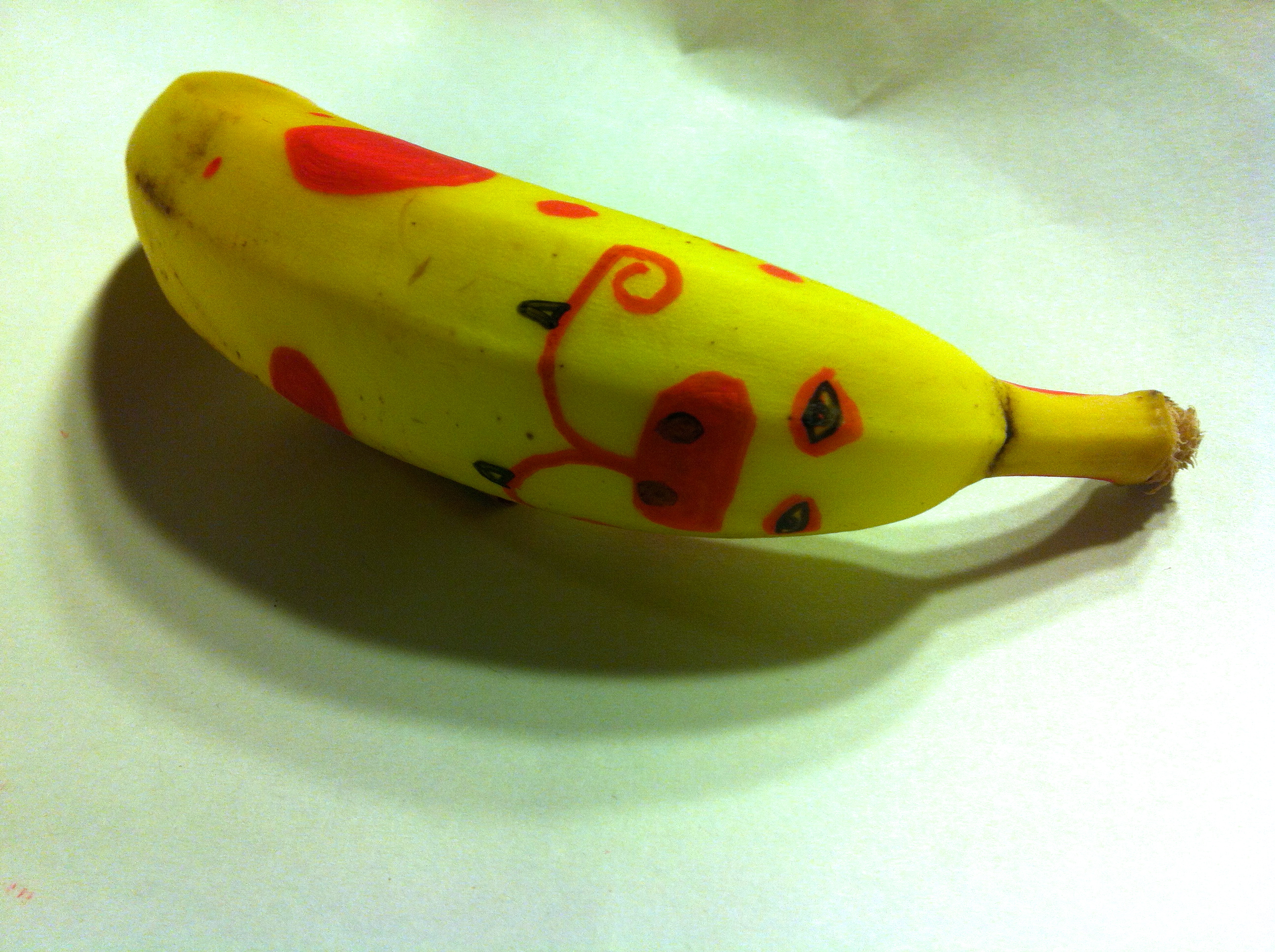Painted banana, red spots on a yellow banana creates a cartoon leopard.
