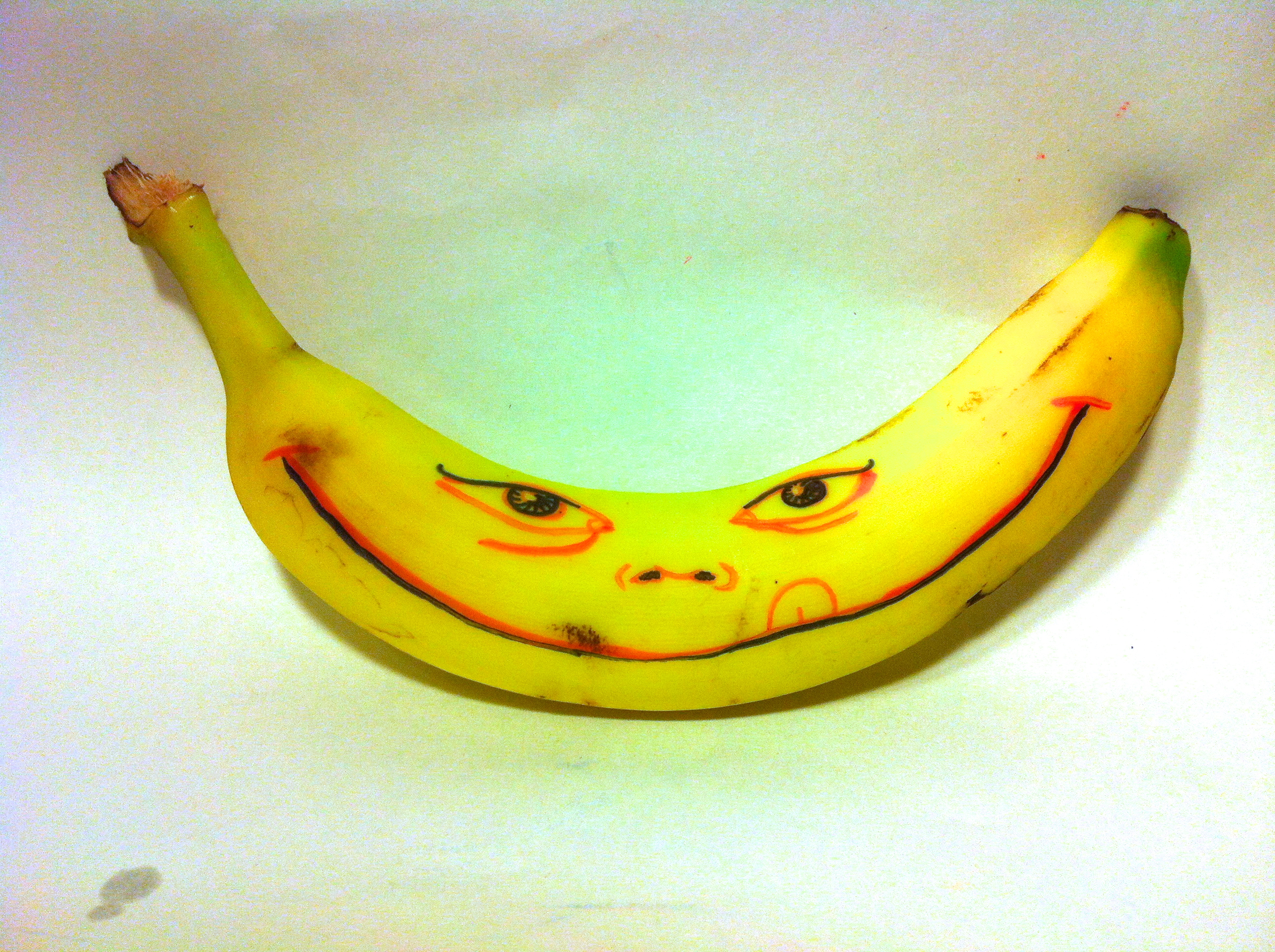 Smiley face drawn on a banana.