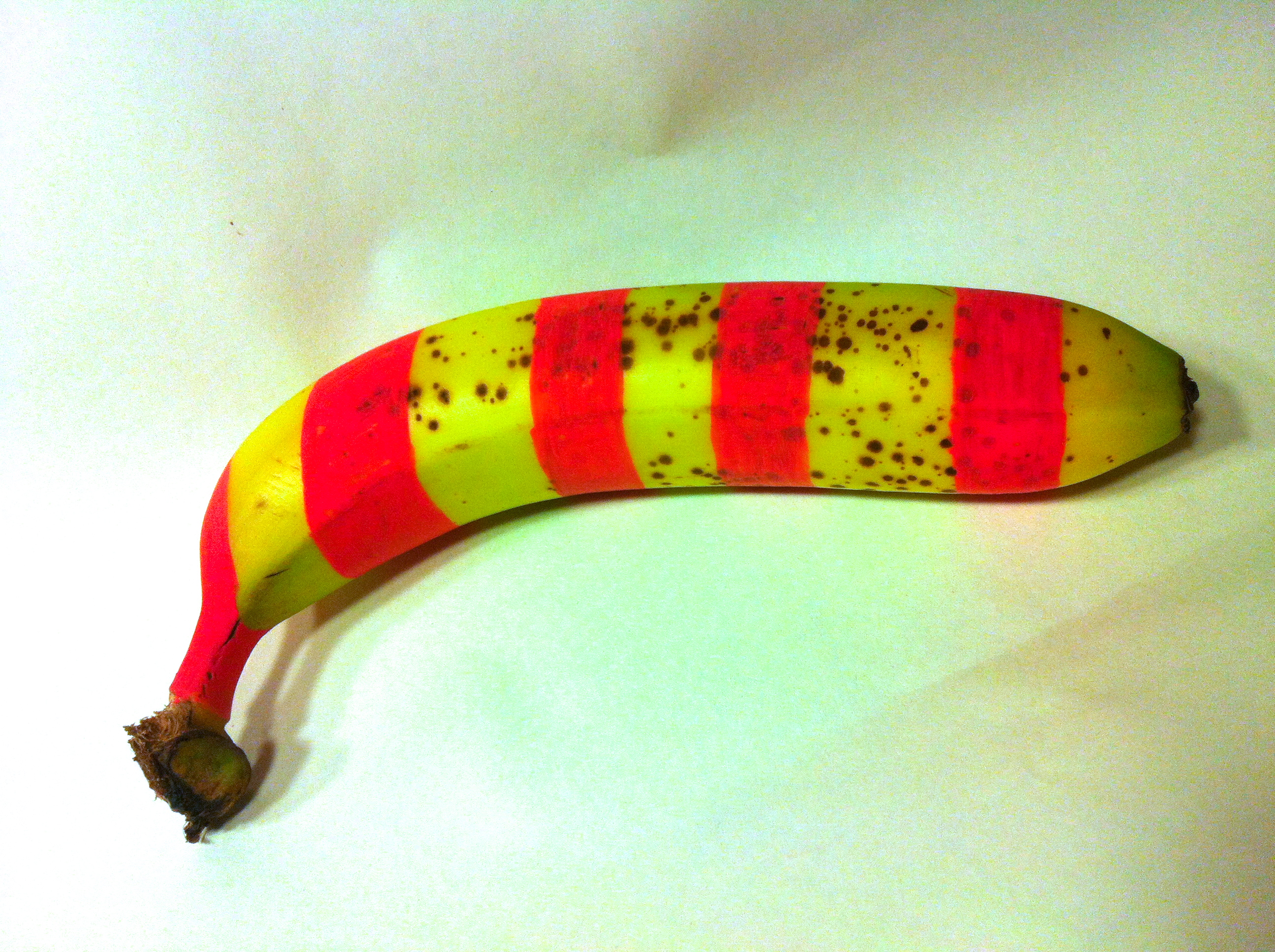 Painted banana with red stripes.