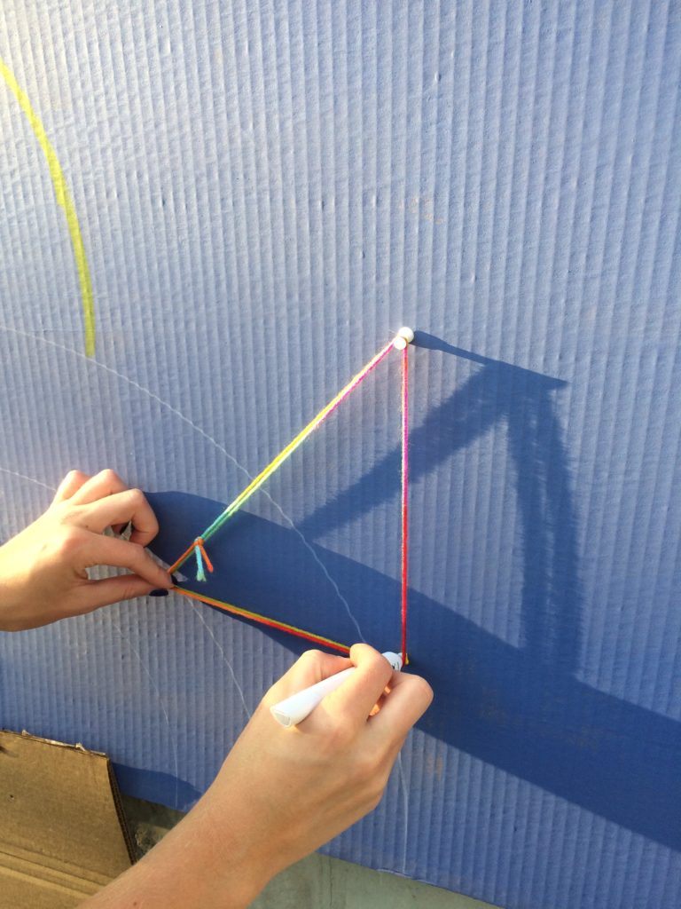 Using tacks and string to make ellipses.
